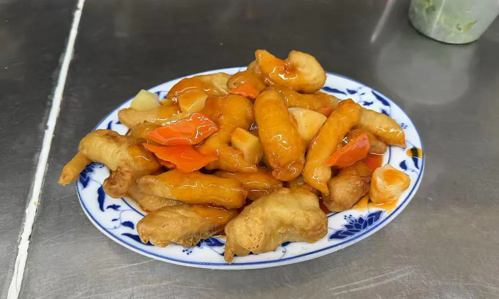 Sweet and sour fried chicken with pineapple, carrots, and glossy orange sauce at Imperial Garden, a Chinese Restaurant in Philadelphia