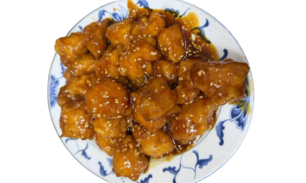 Sesame chicken coated in sweet brown sauce with toasted sesame seeds at Imperial Garden, a Chinese Restaurant in Philadelphia